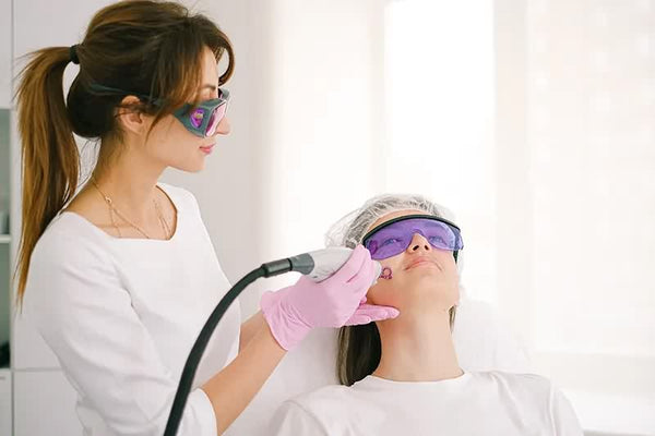 Technician performing laser hair removal by safety guidelines